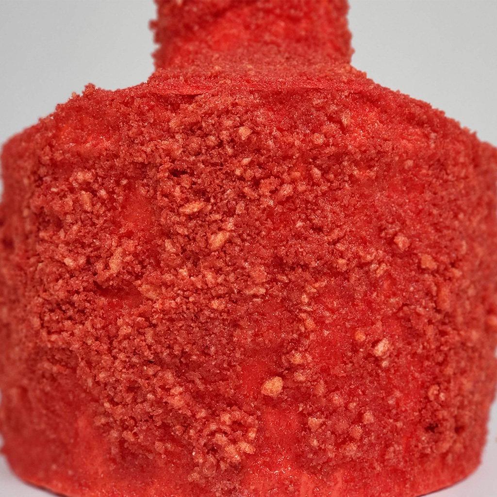 A abstract piston sculpture covered in hot Cheeto dust